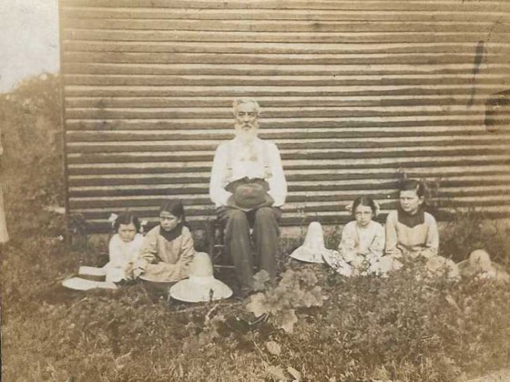 Family on the porch of the old farmhouse
